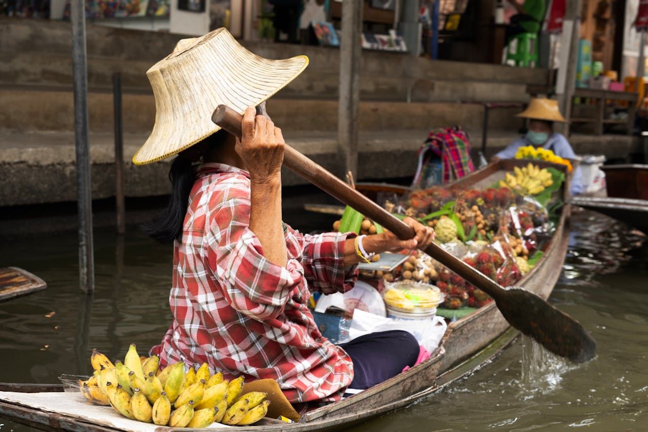vendors selling bananas and other fruits at floating market