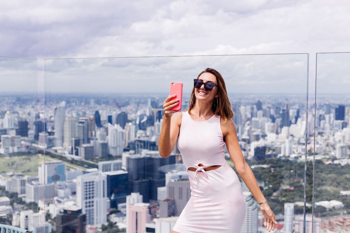 Woman is taking selfie on Mahanakhon Skywalk